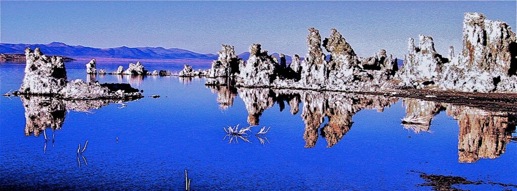 Mono Lake tufa towers mirrored in deep blue water, California